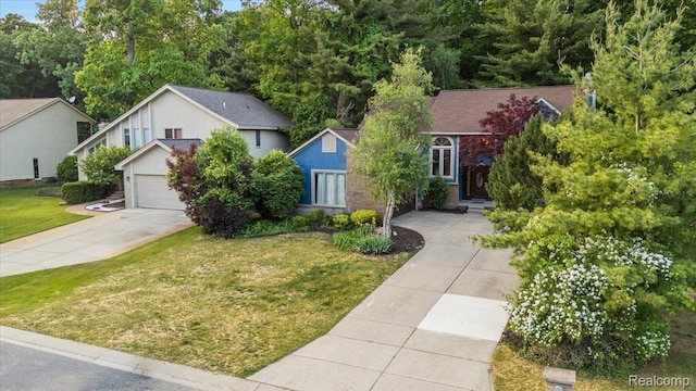 2696 Cedar Key Dr, Lake Orion, MI 48360 - obstructed view of property with concrete driveway and a front yard