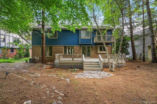 2696 Cedar Key Dr, Lake Orion, MI 48360 - rear view of property featuring brick siding, a deck, and a balcony
