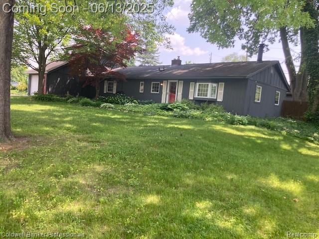 290 Florawood Blvd, Waterford, MI 48327 - ranch-style house with a front lawn, a chimney, and a garage