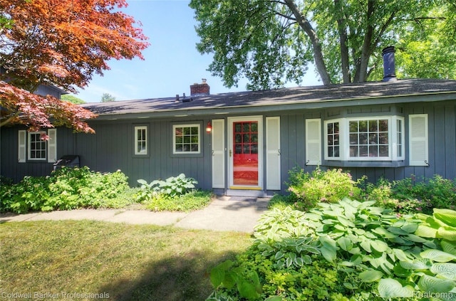290 Florawood Blvd, Waterford, MI 48327 - ranch-style home featuring a chimney and board and batten siding