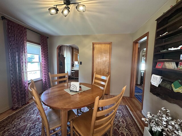 501 W 13th St, Cadillac, MI 49601 - dining space with arched walkways, wood finished floors, and ceiling fan