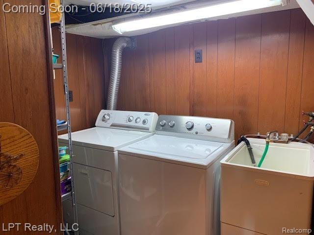 1811 Goddard Rd, Lincoln Park, MI 48146 - washroom featuring washing machine and clothes dryer and wood walls