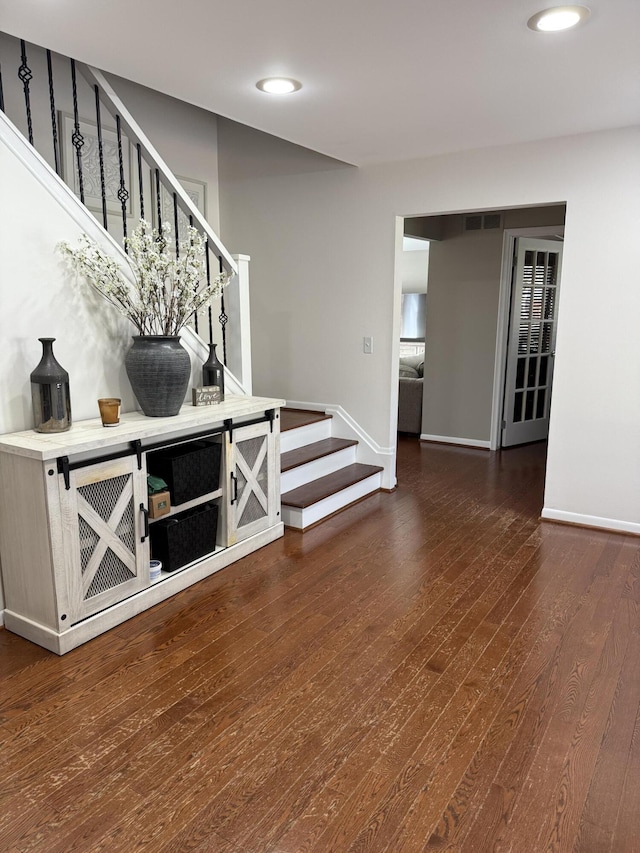 5653 Powder Horn Dr, West Bloomfield, MI 48322 - unfurnished room with stairs, wood finished floors, and recessed lighting
