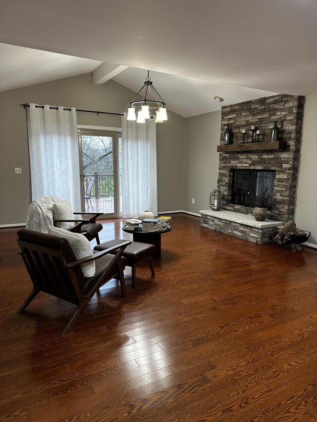5653 Powder Horn Dr, West Bloomfield, MI 48322 - living room featuring dark wood-style floors, a stone fireplace, and a chandelier