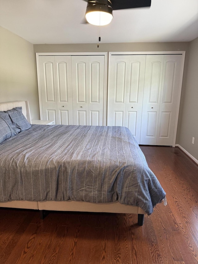 5653 Powder Horn Dr, West Bloomfield, MI 48322 - bedroom with two closets, wood finished floors, and a ceiling fan