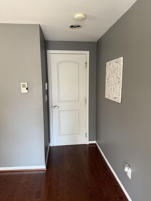5653 Powder Horn Dr, West Bloomfield, MI 48322 - corridor with dark wood-type flooring and baseboards