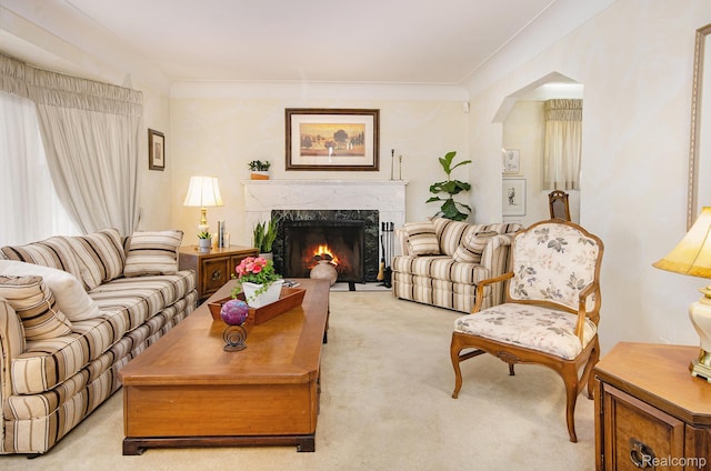 16251 Prest St, Detroit, MI 48235 - living room featuring light colored carpet, a high end fireplace, and arched walkways