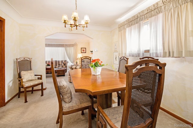 16251 Prest St, Detroit, MI 48235 - dining space featuring a chandelier, light carpet, arched walkways, and ornamental molding