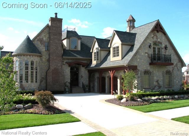 17014 Abby Cir, Northville, MI 48168 - french country inspired facade with stone siding, a chimney, and a balcony