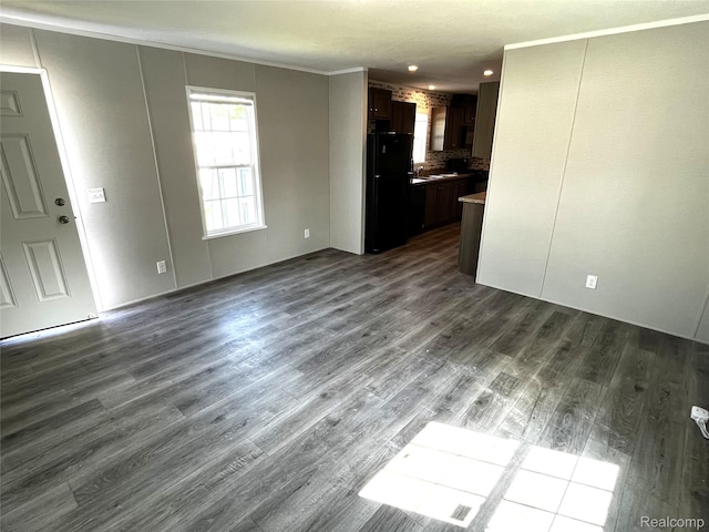 1048 Pheasant Dr, Bay City, MI 48706 - unfurnished living room with dark wood finished floors and crown molding