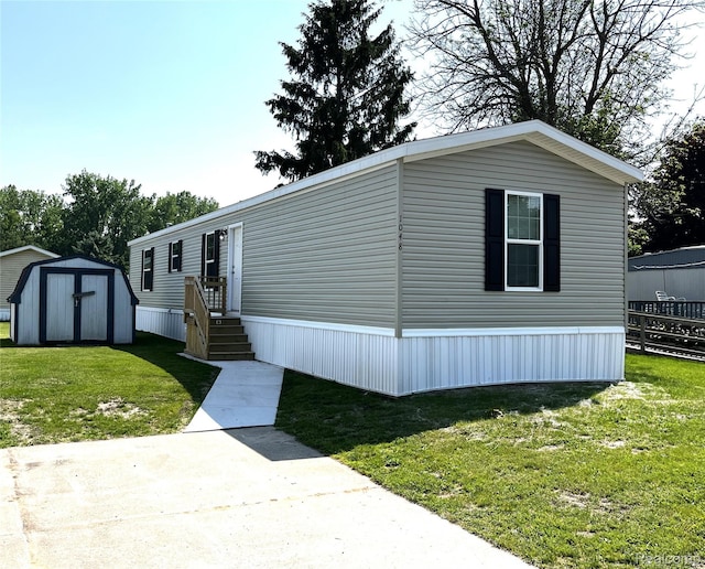 1048 Pheasant Dr, Bay City, MI 48706 - manufactured / mobile home with a storage unit and a front lawn