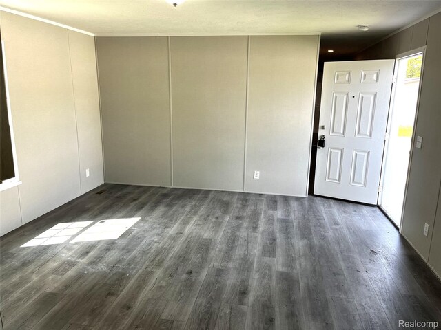 1048 Pheasant Dr, Bay City, MI 48706 - unfurnished room with dark wood-type flooring, a smoke detector, and ornamental molding