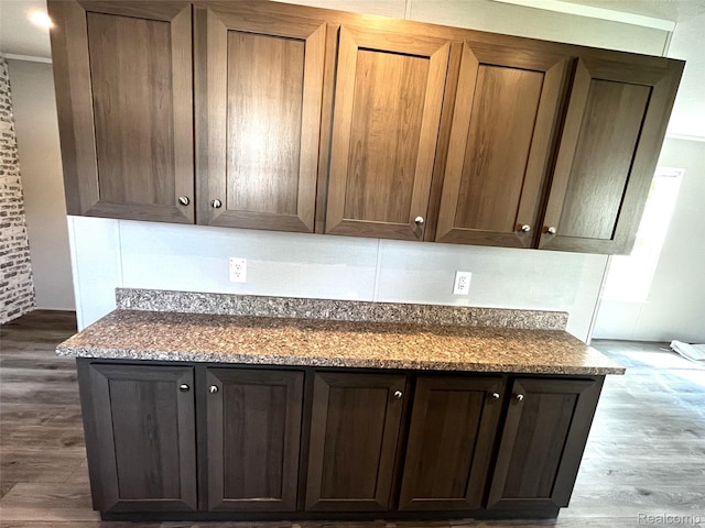 1048 Pheasant Dr, Bay City, MI 48706 - kitchen with dark wood-style floors, dark stone countertops, and dark brown cabinets