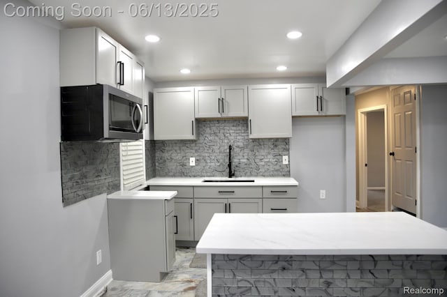 9037 Longacre St, Detroit, MI 48228 - kitchen with stainless steel microwave, tasteful backsplash, and recessed lighting
