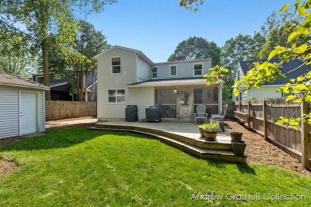 1142 Orchard Ave SE, Grand Rapids, MI 49506 - back of house featuring a fenced backyard, a chimney, an outdoor structure, and a wooden deck