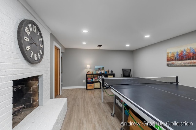 1142 Orchard Ave SE, Grand Rapids, MI 49506 - recreation room featuring light wood finished floors, recessed lighting, and a fireplace