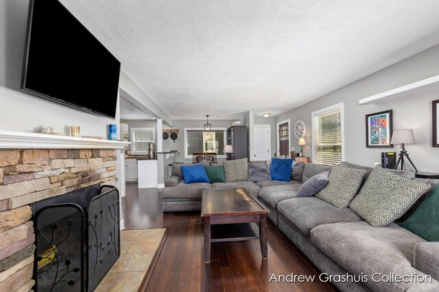 1142 Orchard Ave SE, Grand Rapids, MI 49506 - living area featuring hardwood / wood-style floors, a textured ceiling, and a fireplace