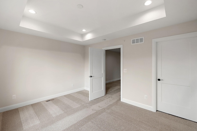 7479 Gramercy Cir W, Bloomfield, MI 48322 - unfurnished bedroom with a raised ceiling, recessed lighting, and light carpet
