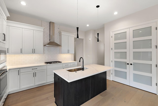 7479 Gramercy Cir W, Bloomfield, MI 48322 - kitchen with wall chimney range hood, light wood finished floors, backsplash, gas stovetop, and recessed lighting