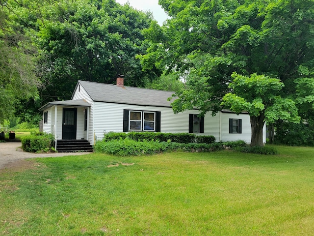10765 Northland Dr, Big Rapids, MI 49307 - view of front of house with a front lawn and a chimney