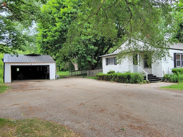 10765 Northland Dr, Big Rapids, MI 49307 - view of side of home with an outbuilding and a garage