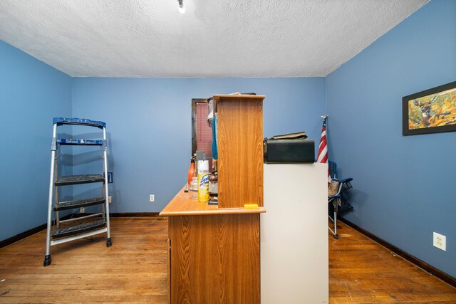 10765 Northland Dr, Big Rapids, MI 49307 - office area with wood-type flooring and a textured ceiling