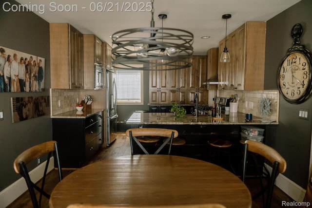 619 E Farnum Ave, Royal Oak, MI 48067 - kitchen with appliances with stainless steel finishes, light stone counters, tasteful backsplash, brown cabinets, and a peninsula