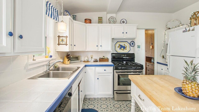 1194 Beach Dr, Holland, MI 49423 - kitchen with appliances with stainless steel finishes, white cabinetry, tile counters, and backsplash