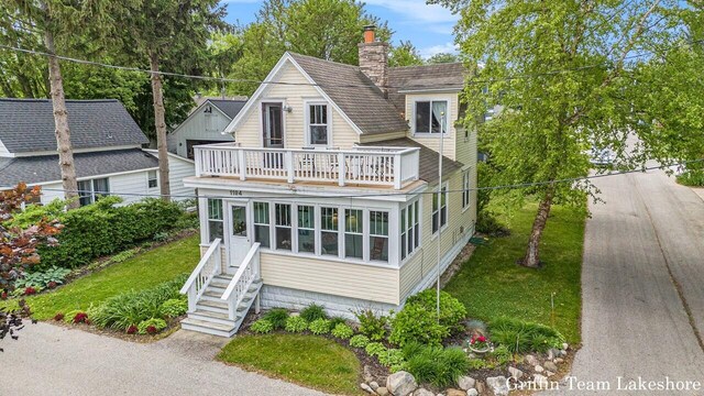 1194 Beach Dr, Holland, MI 49423 - view of front of home with a balcony and a chimney