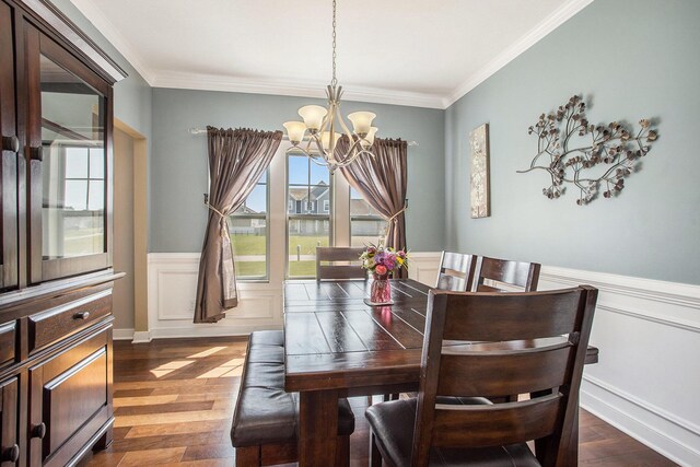 7990 Hemel Ln, Richland, MI 49083 - dining room with a chandelier, wainscoting, ornamental molding, dark wood-style floors, and a decorative wall