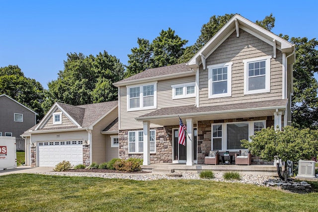 7990 Hemel Ln, Richland, MI 49083 - craftsman-style house with a garage, a front lawn, stone siding, and a shingled roof