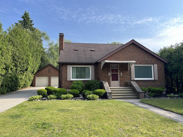 261 W Main St, Hart, MI 49420 - view of front facade featuring a chimney, brick siding, an outbuilding, a garage, and a front lawn