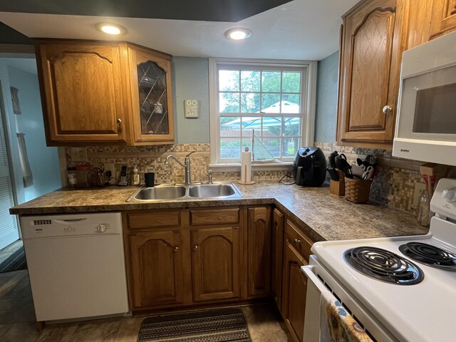 261 W Main St, Hart, MI 49420 - kitchen featuring white appliances, decorative backsplash, glass insert cabinets, brown cabinets, and recessed lighting