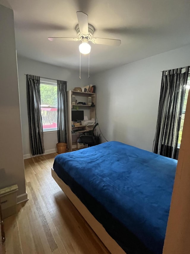261 W Main St, Hart, MI 49420 - bedroom with light wood-style floors and ceiling fan