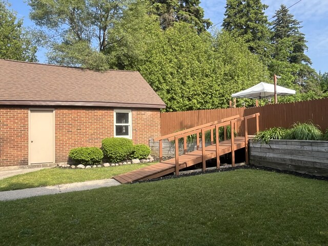 261 W Main St, Hart, MI 49420 - back of house featuring brick siding and a shingled roof