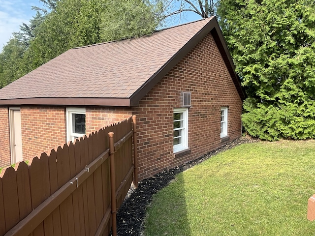 261 W Main St, Hart, MI 49420 - view of side of property featuring brick siding and roof with shingles