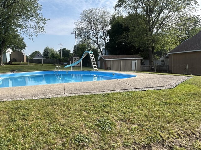 261 W Main St, Hart, MI 49420 - view of pool featuring a storage unit, a water slide, and a diving board