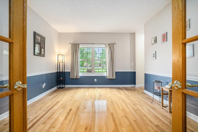 17872 Victors Ln, Marshall, MI 49068 - spare room with wood finished floors and a textured ceiling