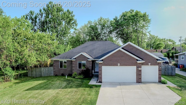 24986 Murray St, Harrison Township, MI 48045 - view of front of house featuring an attached garage, brick siding, and driveway