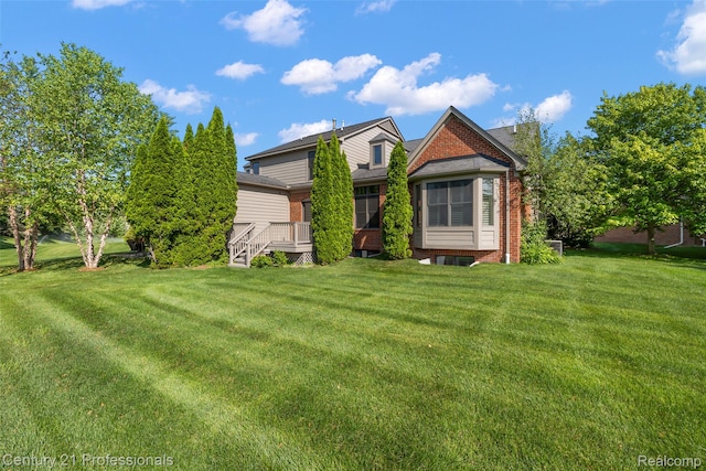 4013 Ardsley Ct, Clarkston, MI 48348 - rear view of property with brick siding, a lawn, and a wooden deck