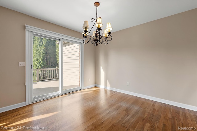 4013 Ardsley Ct, Clarkston, MI 48348 - spare room with a chandelier and wood finished floors