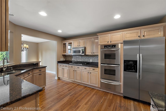 4013 Ardsley Ct, Clarkston, MI 48348 - kitchen featuring stainless steel appliances, a warming drawer, light wood finished floors, a chandelier, and recessed lighting