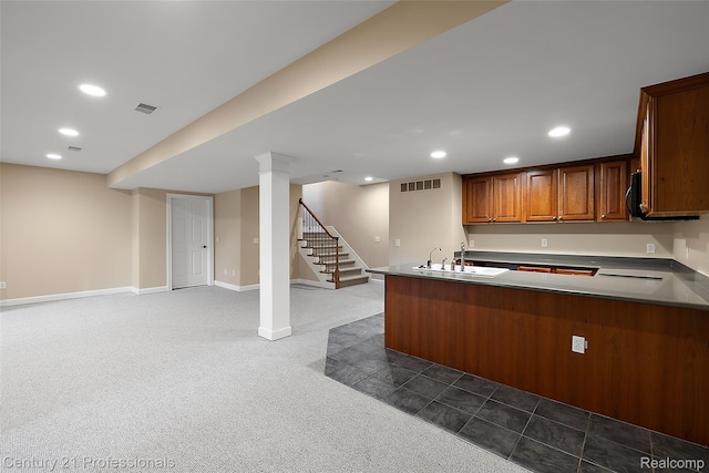 4013 Ardsley Ct, Clarkston, MI 48348 - kitchen with open floor plan, dark carpet, recessed lighting, a peninsula, and brown cabinetry