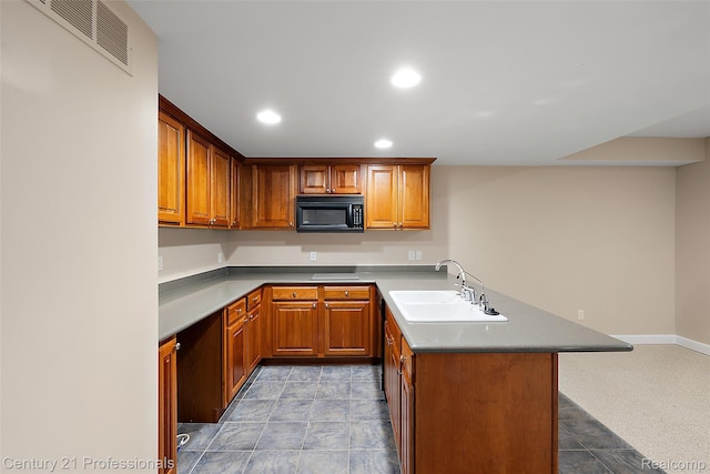 4013 Ardsley Ct, Clarkston, MI 48348 - kitchen with black microwave, a peninsula, recessed lighting, brown cabinets, and a kitchen bar