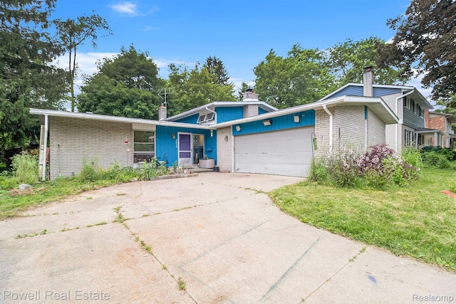 2830 Colony, Ann Arbor, MI 48104 - mid-century inspired home featuring a chimney, brick siding, a garage, and driveway
