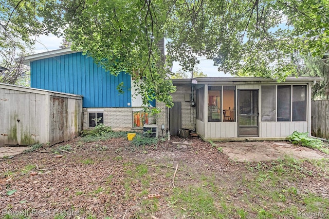 2830 Colony, Ann Arbor, MI 48104 - rear view of house with a sunroom, brick siding, and board and batten siding