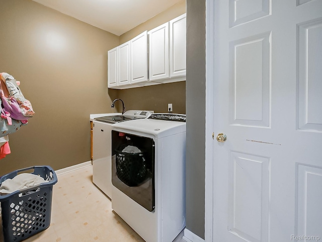 8595 Eastway Dr, White Lake, MI 48386 - laundry area with cabinet space, washing machine and dryer, and light floors