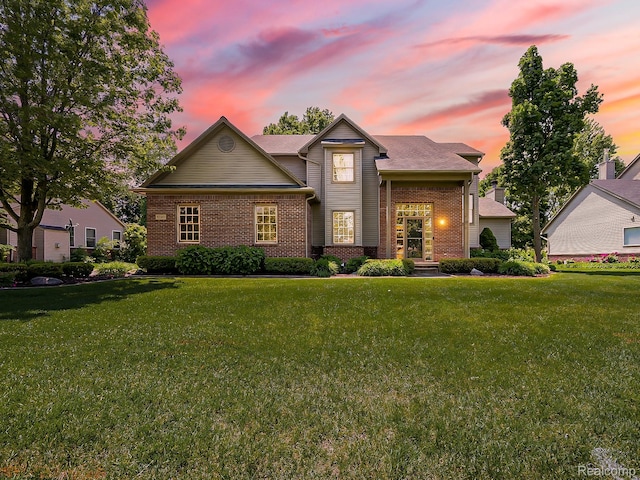 8595 Eastway Dr, White Lake, MI 48386 - traditional home with brick siding and a front lawn