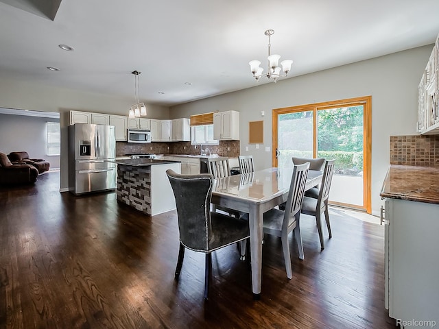 8595 Eastway Dr, White Lake, MI 48386 - dining space featuring a chandelier, plenty of natural light, dark wood finished floors, and recessed lighting