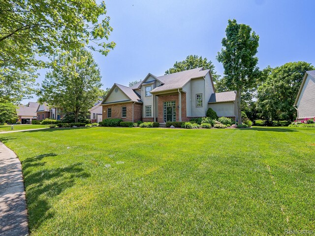 8595 Eastway Dr, White Lake, MI 48386 - view of front of house with brick siding and a front lawn